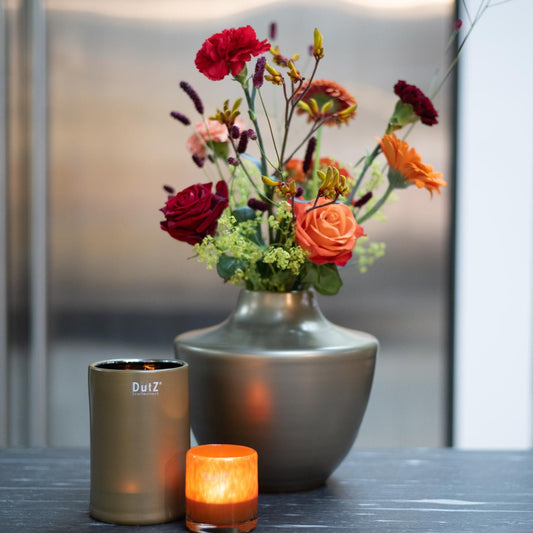 Elegant design vase by Lowlands Design made of glass mouthblown dutz, featuring vibrant floral arrangement