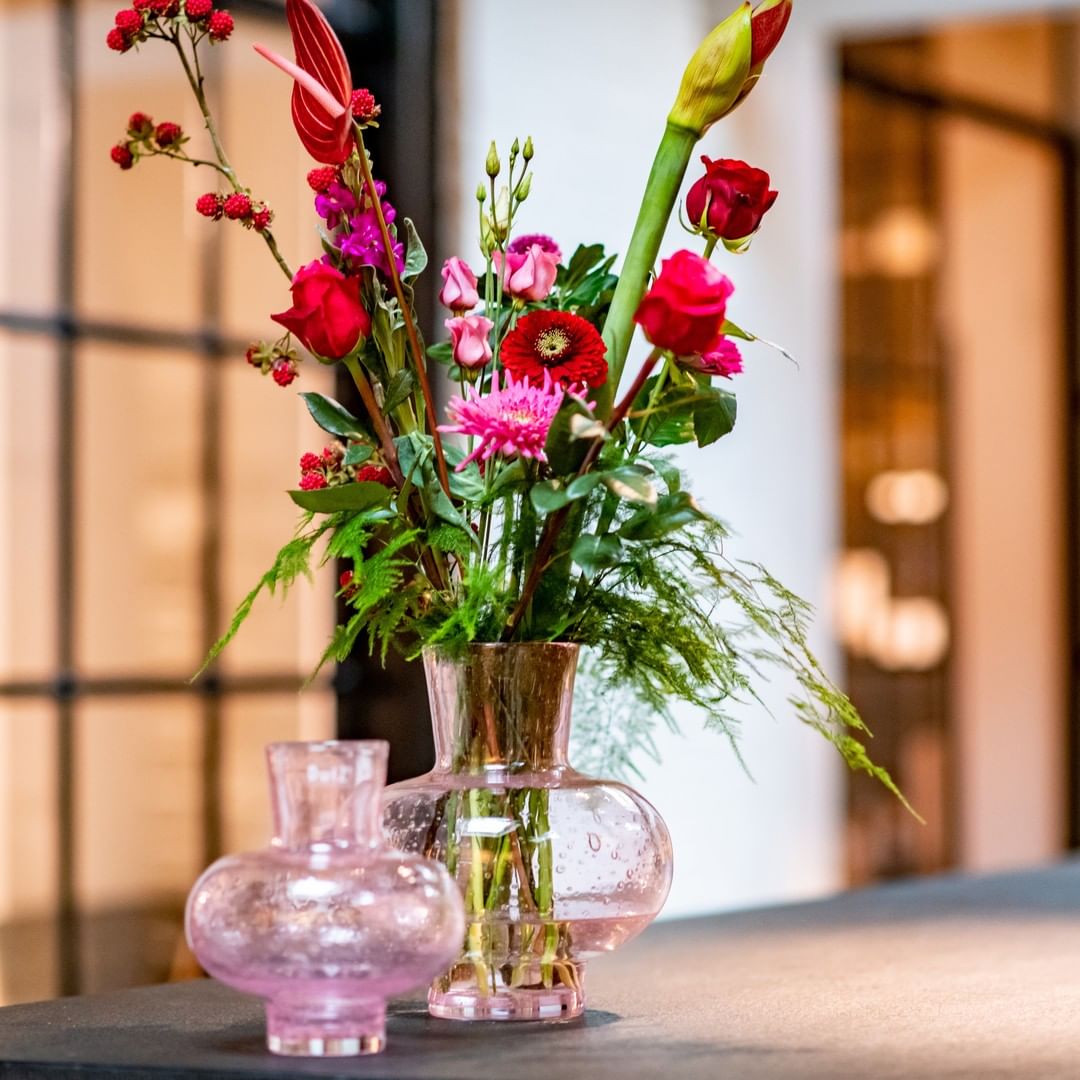 Lowlands Design Glass Posy Vase in pink with vibrant floral arrangement for home decoration