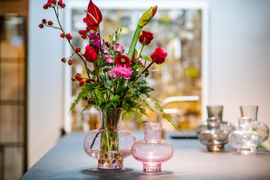 Glass Posy Vase from Lowlands Design filled with vibrant flowers on a contemporary table
