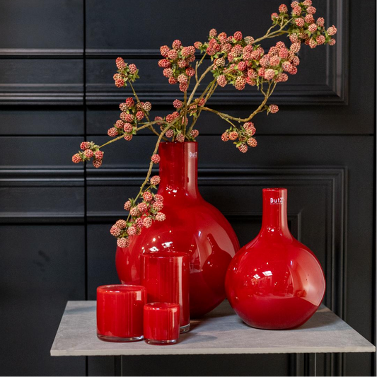Lowlands Design mouthblown glass bottle vase in vibrant red with decorative flowers and candles