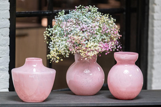 Lowlands Design trio of pink designer vase display with central round vase holding pastel gypsophila flowers