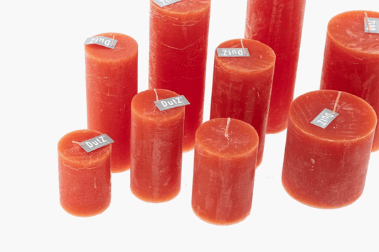 Lowlands Design red pillar candles in assorted sizes with rustic finish on white background