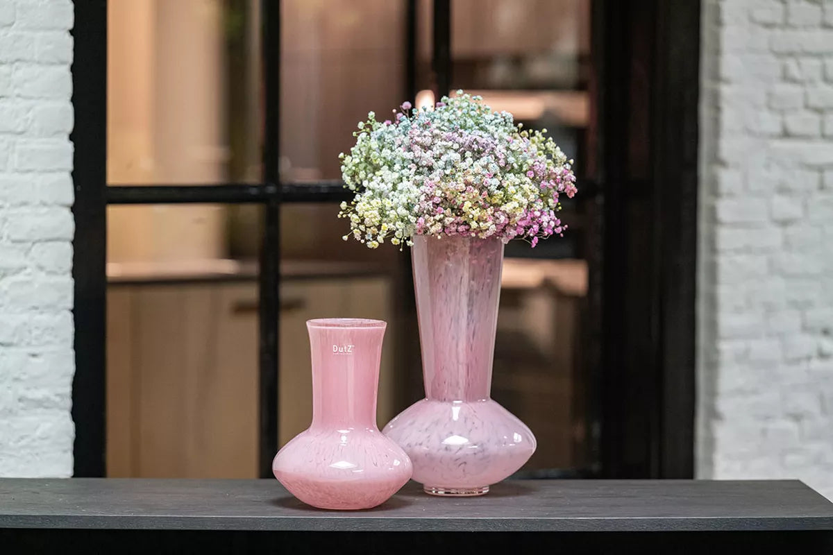 Lowlands Design rose pink glass vase pair with tall vase holding delicate gypsophila and shorter matching bulb vase