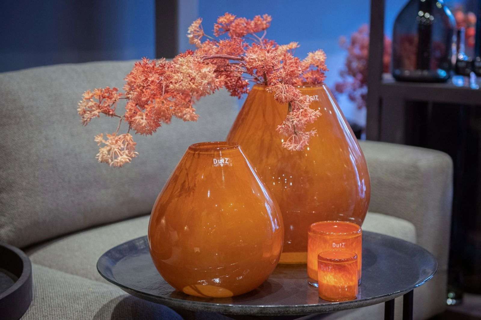 Lowlands Design amber glass vase set on a black table with dried flowers for modern home decor