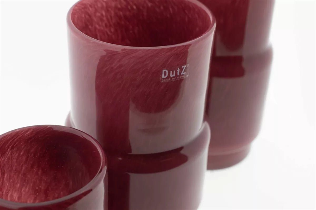 Close-up of maroon design vase by Lowlands Design with smooth glossy finish and modern shape