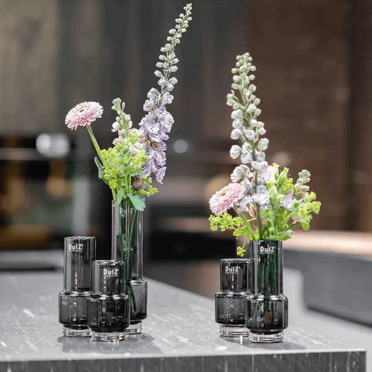 Lowlands Design black glass vase set with fresh flowers on a modern kitchen countertop