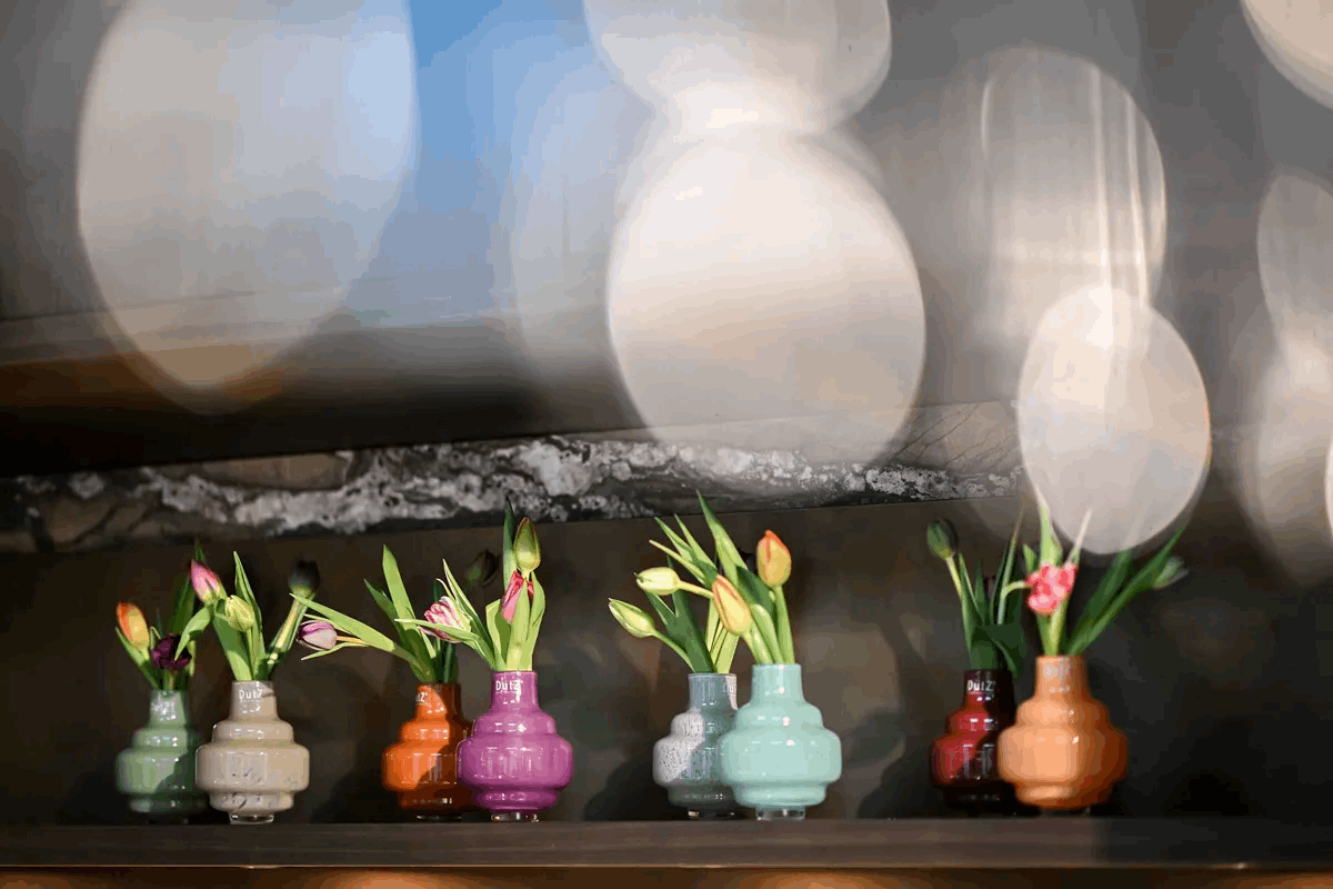 Lowlands Design colorful vase small collection with tulips displayed on wooden shelf