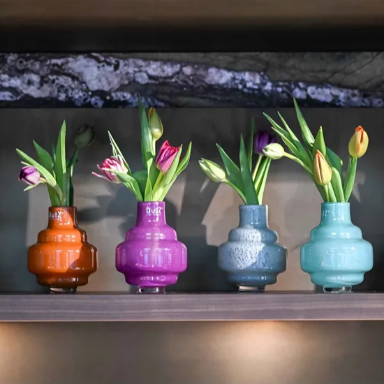 Lowlands Design colorful small vases small with tulips in orange purple blue and teal colors
