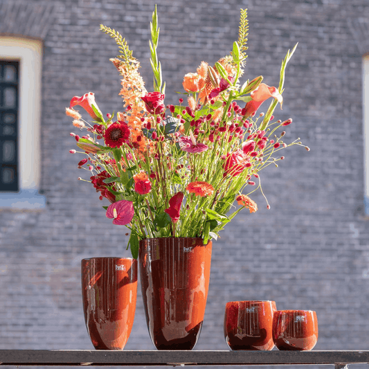 Elegant Lowlands Design flowervase glass in amber with vibrant floral arrangement for home decor