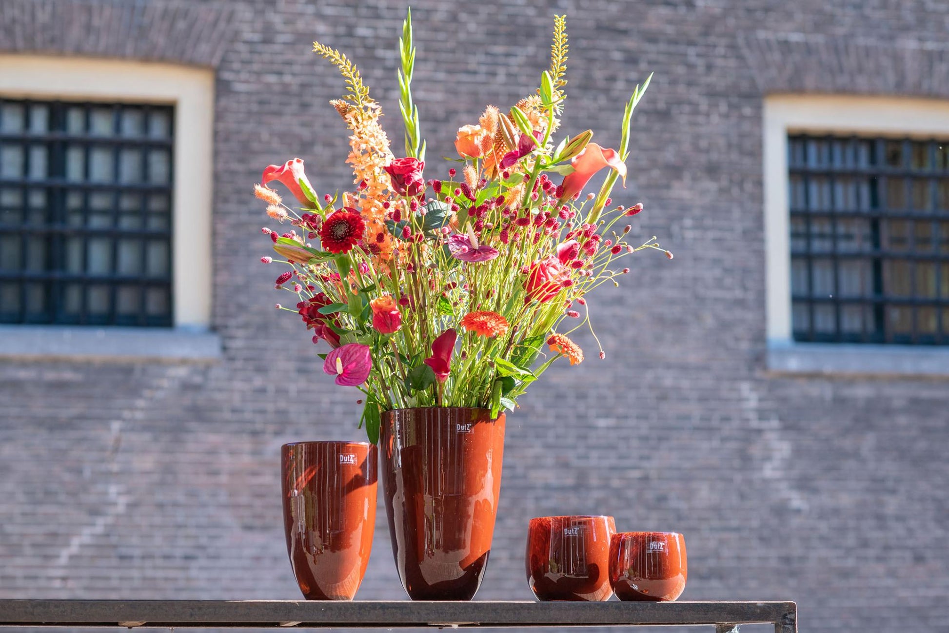 Elegant Lowlands Design flowervase glass featuring a vibrant floral arrangement in a stylish setting