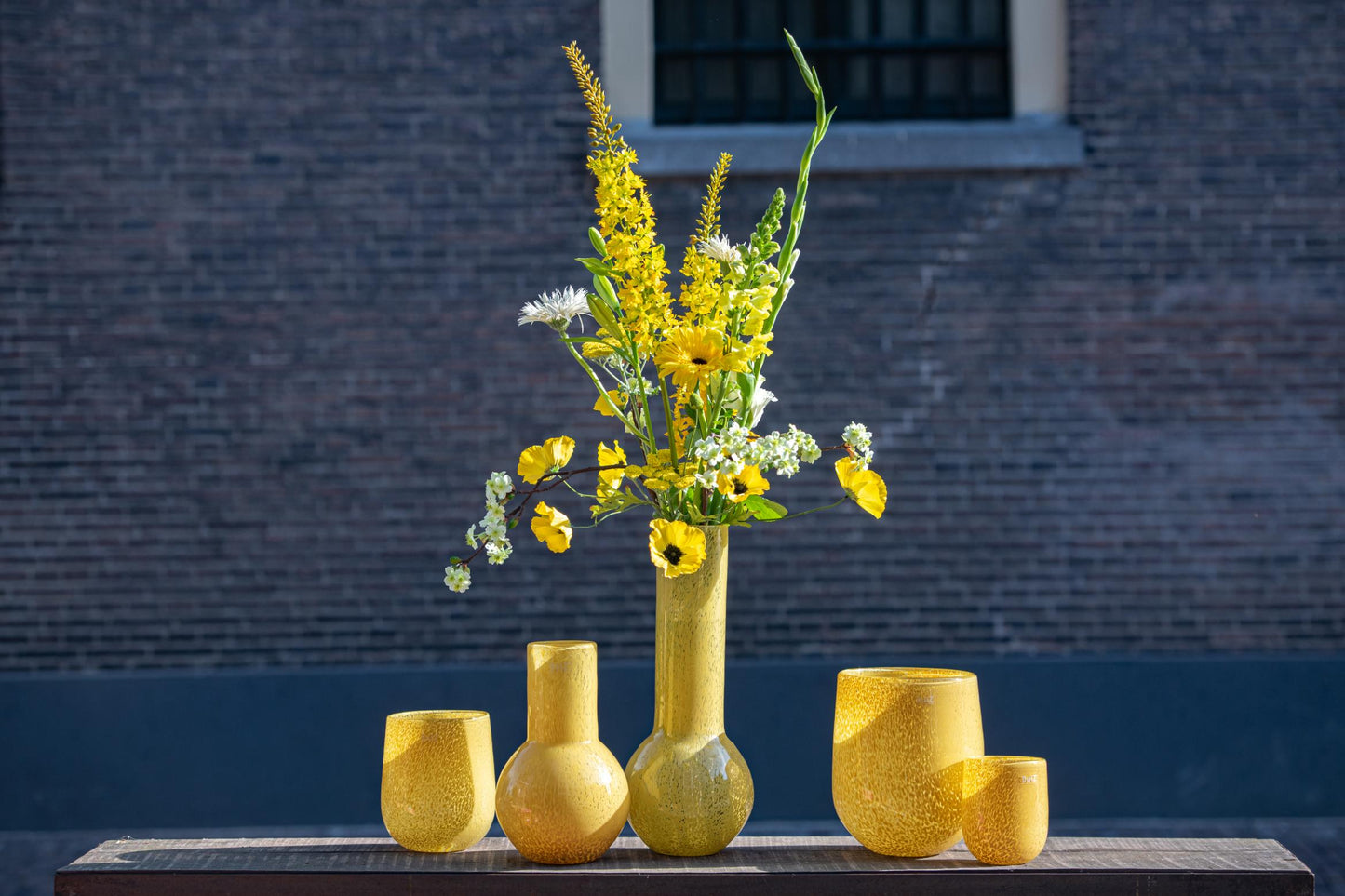 Lowlands Design Glass BARREL vase candleholder in yellow displaying flowers and greenery