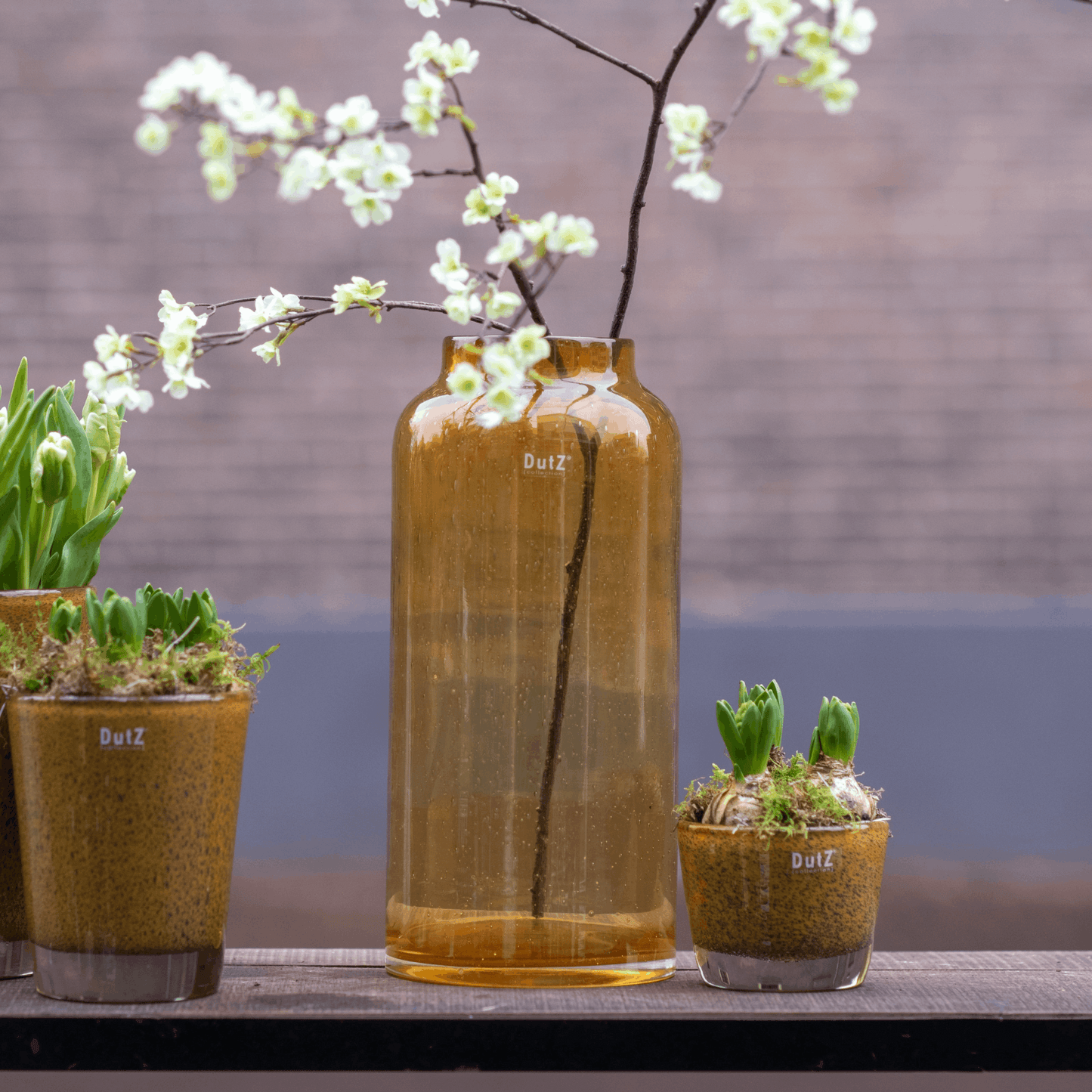 Glass Flowervase BARREL from Lowlands Design with decorative flowers and potted plants