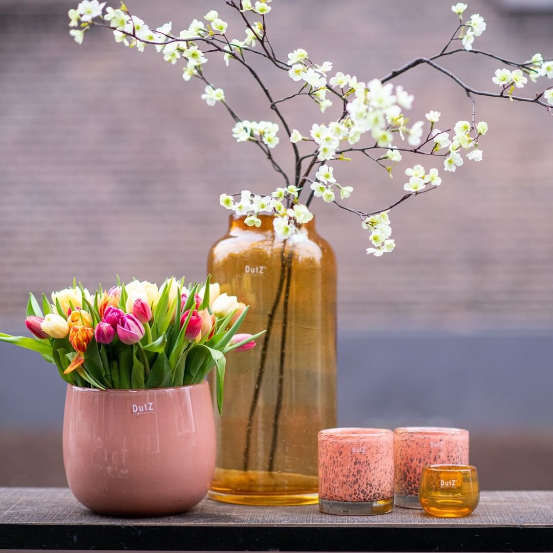 Stylish Lowlands Design Glass Flowervase BARREL with colourful tulips and decorative candles on a table