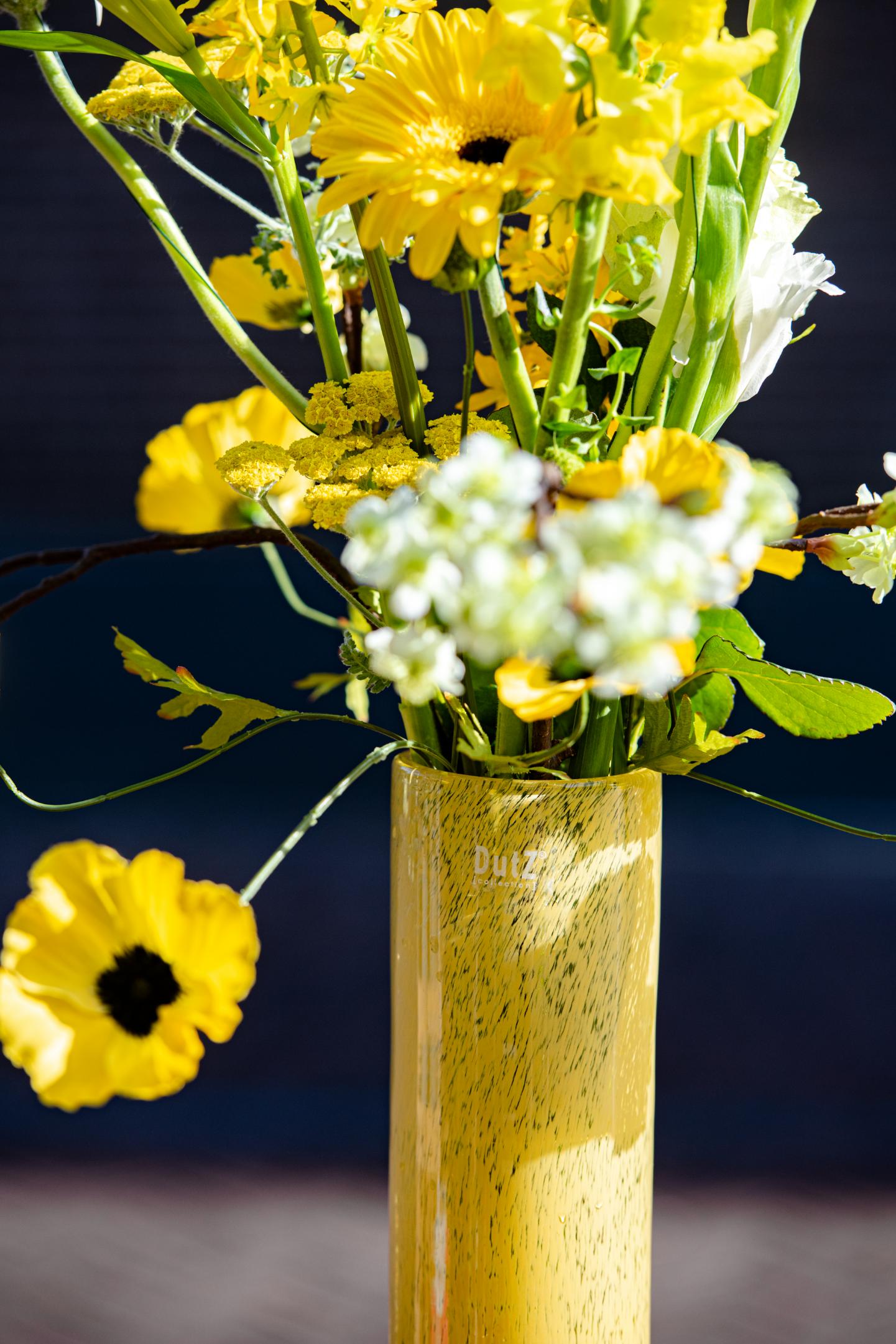 Stylish Centrepiece with Yellow Flowers in a Glass Flowervase from Lowlands Design