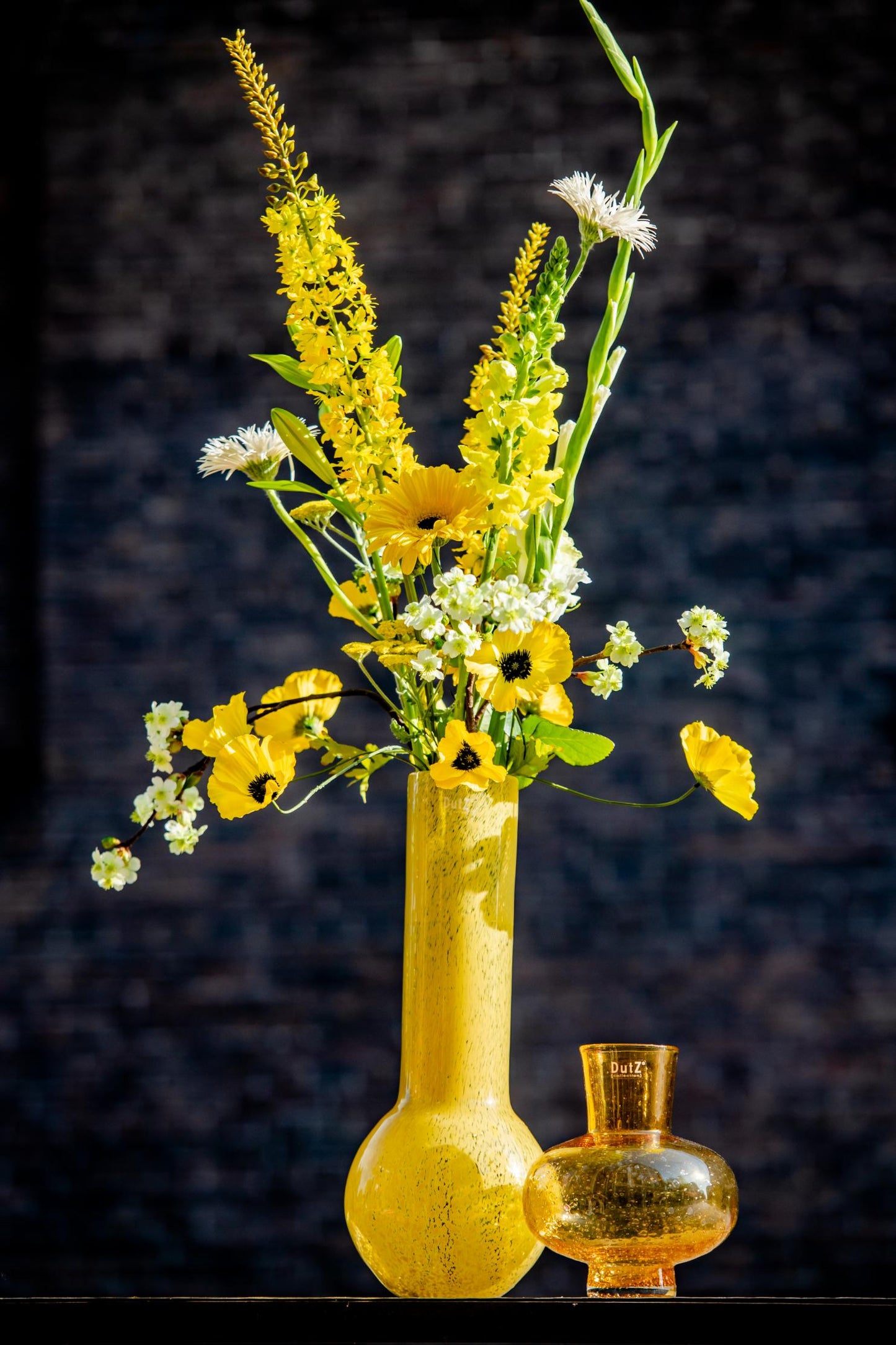 Lowlands Design Glass Flowervase - Stylish Centrepiece featuring vibrant yellow flowers and a decorative orange vase