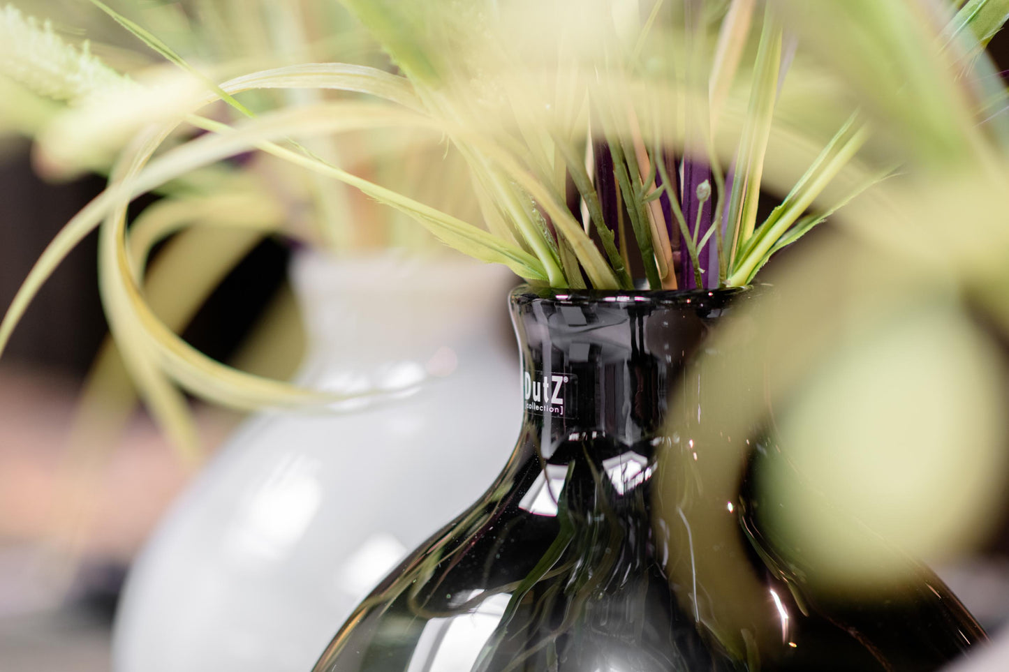 Elegant Lowlands Design glass lighgrey vase with decorative floral arrangement