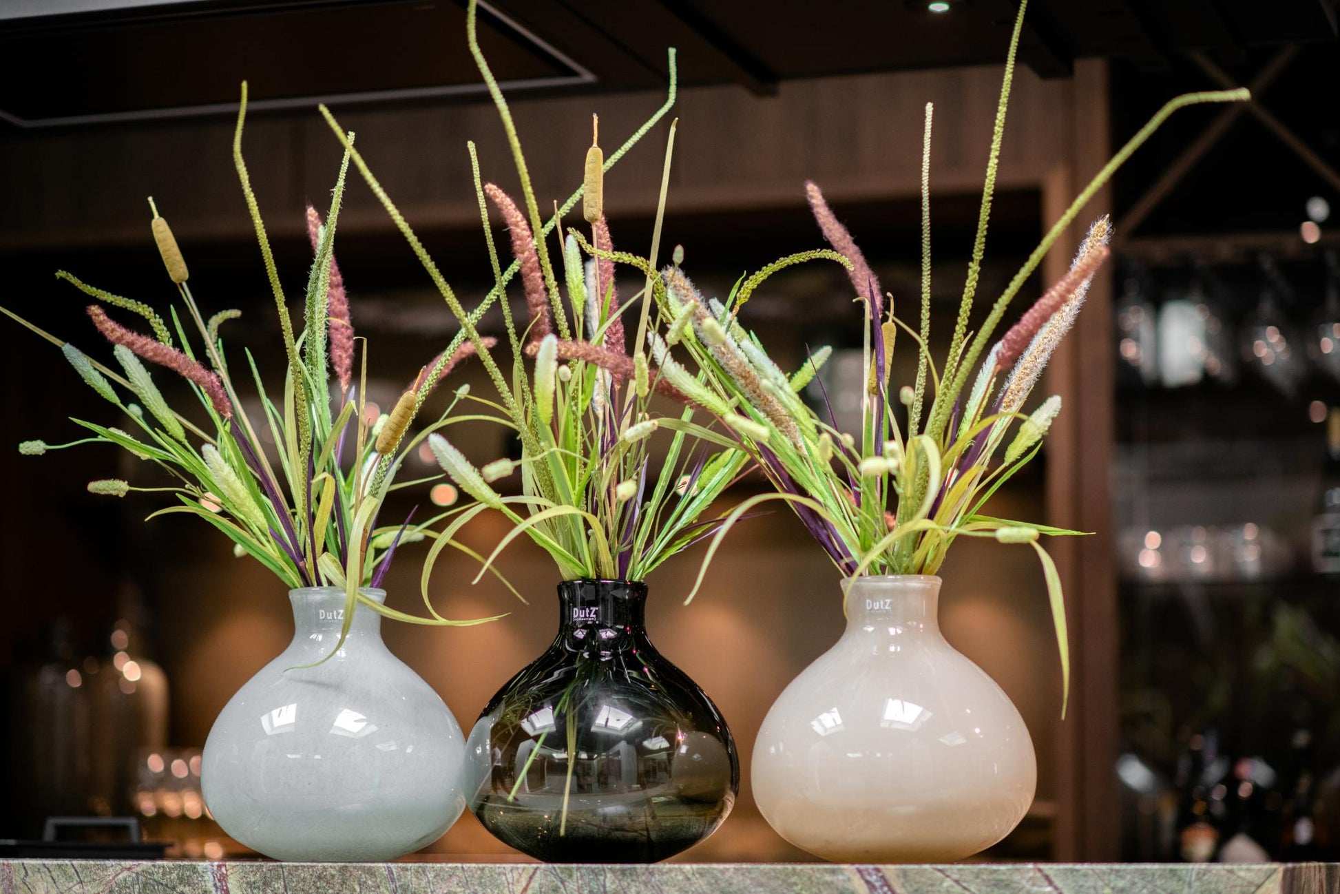 Set of three Lowlands Design glass lighgrey vase with colourful floral arrangements for elegant decor