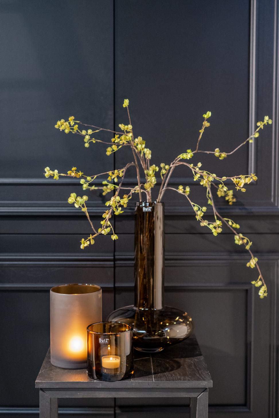 Elegant Lowlands Design mouthblown glass vase filled with delicate branches and candles for stylish decoration