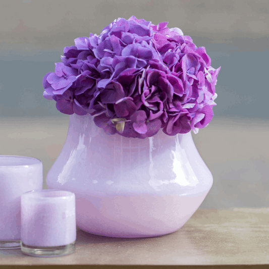 Lowlands Design orchid pot glass lical with purple hydrangea flowers and decorative candles