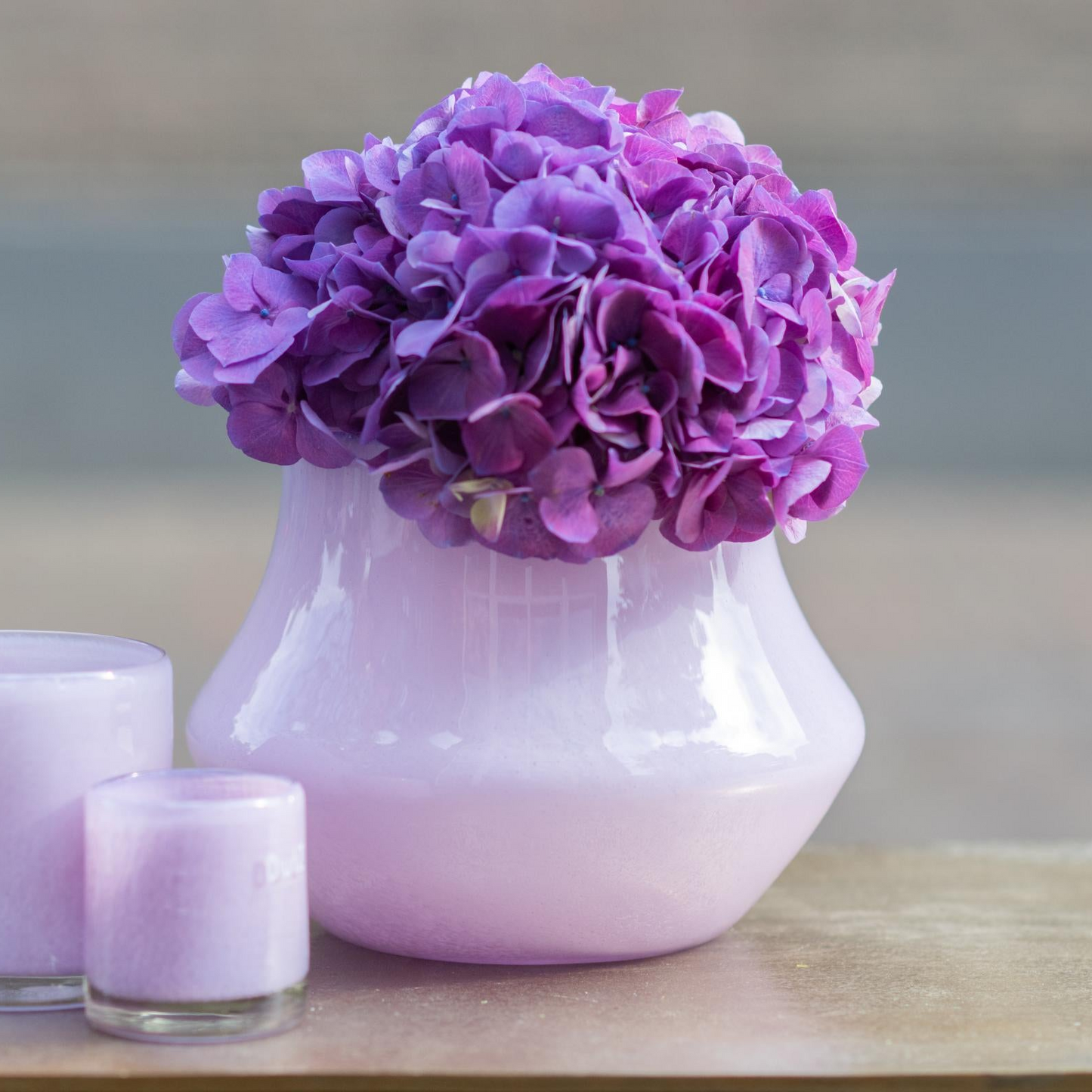 Lowlands Design orchid pot glass lical with purple hydrangea flowers and decorative candles